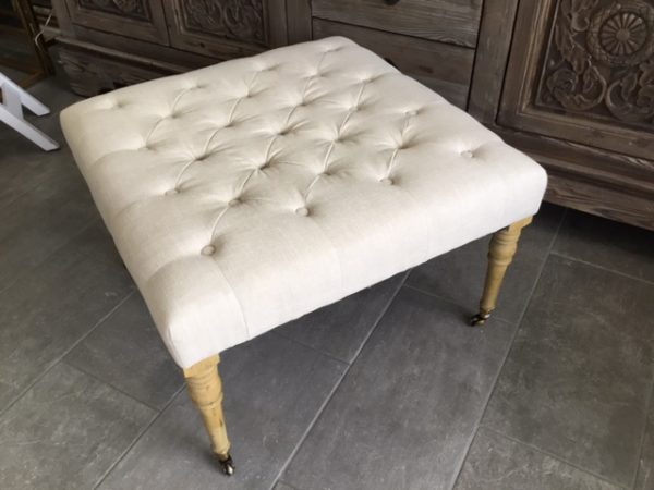 ROLLING TUFTED OTTOMAN